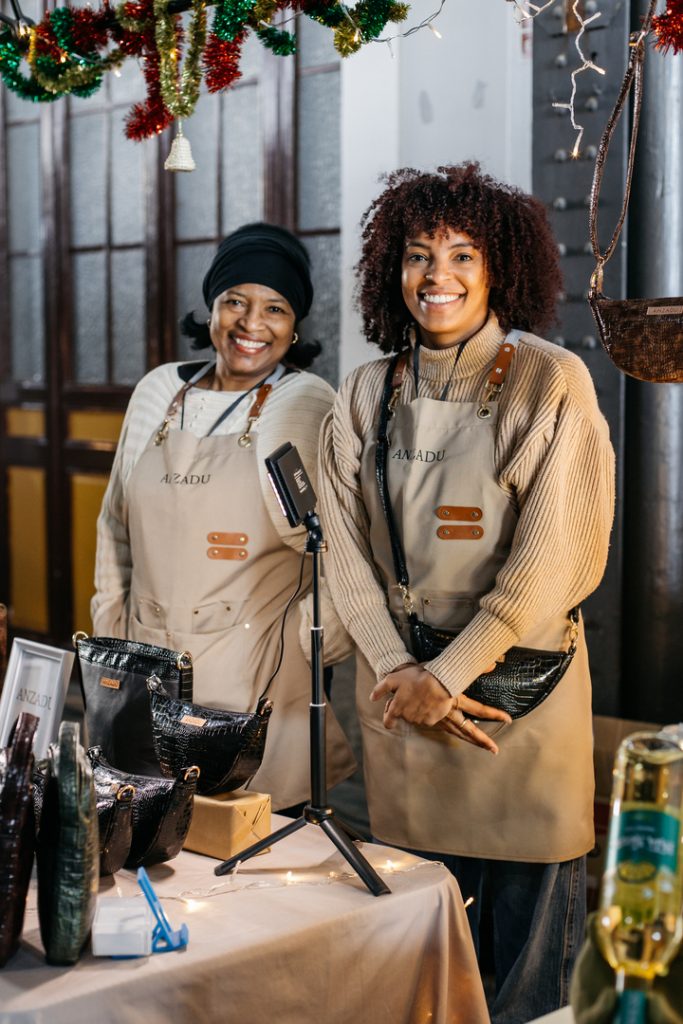 Equipo Anzadu, Mercado de Motores, exponiendo colección de artículos elaborados en piel sintética.